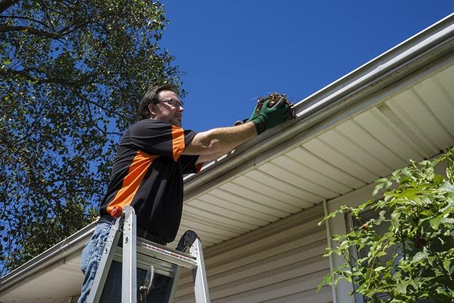 a technician replacing a section of damaged gutter in Dolton